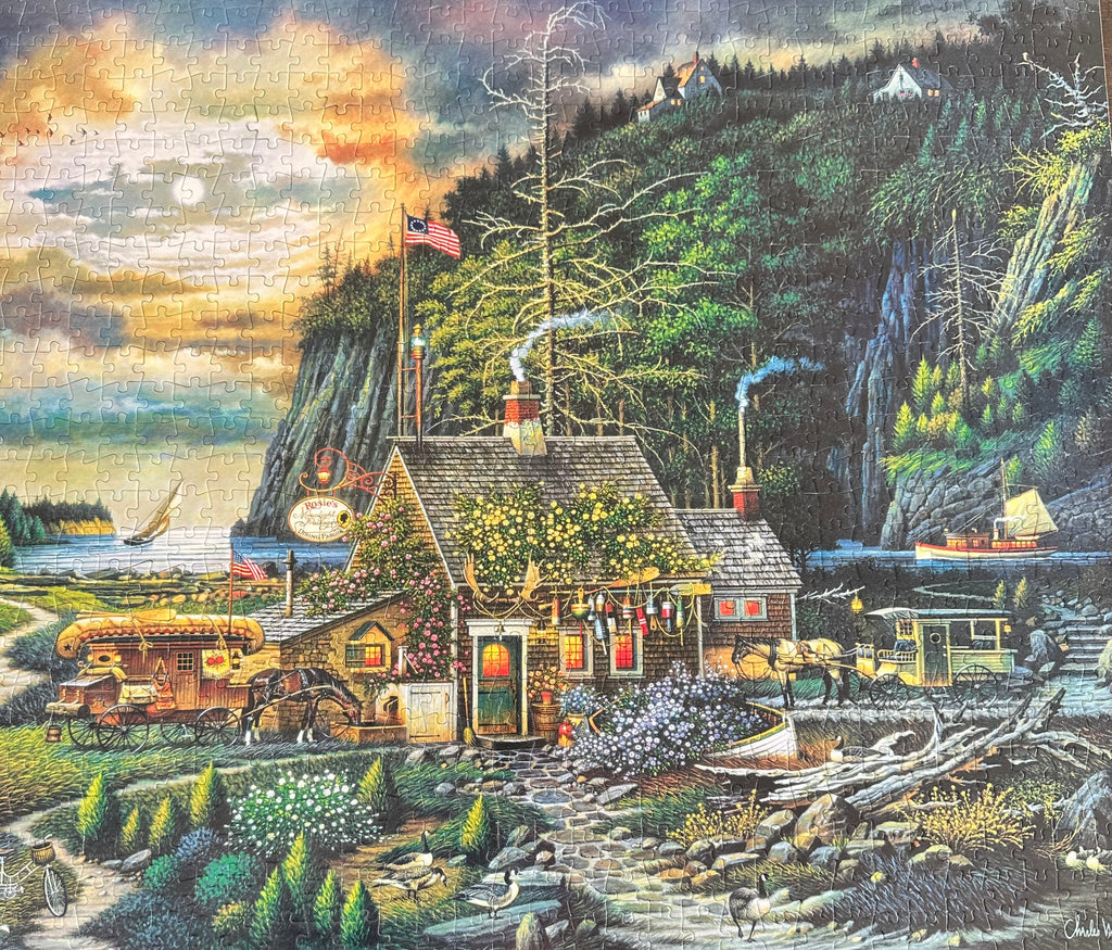 puzzle of a rustic cabin by a lake with a mountainous background